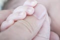 Hand of newborn. Hands of father and son united. Maternity and p