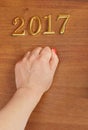 Hand and numbers 2017 on door - new year background Royalty Free Stock Photo