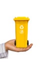 Hand offer yellow trash can