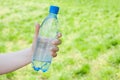 Hand offering bottle of water Royalty Free Stock Photo