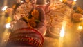 Hand Offering Flowers In Worship. Dark And Blurry Diwali Night.