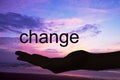 Hand offering the word change, sunset background