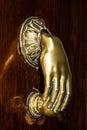 Hand on old door knocker, Kadiz, Spain