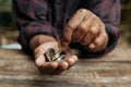 Hand old man begging for money because of the hunger on the wood table Royalty Free Stock Photo