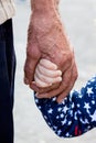 The hand of an old man and the hand of a little girl. Unity of g Royalty Free Stock Photo