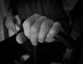 Hand old man on a plastic stick. Black and white photo. Royalty Free Stock Photo