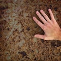 Hand on old rusty metal surface Royalty Free Stock Photo