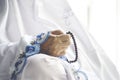 Hand of old woman holding rosary beads Royalty Free Stock Photo