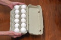 Hand of old Woman holds box eggs