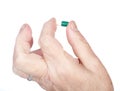 Hand of the old woman holds capsule with medicines Royalty Free Stock Photo