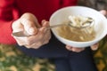 Hand of old woman holds tablespoon of noodle soup Royalty Free Stock Photo