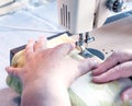 Hand old woman's guide for sewing machine Royalty Free Stock Photo