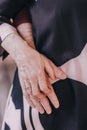 The hand of the old woman who takes her husband& x27;s hand lovingly. Royalty Free Stock Photo