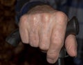 Hand of old, worn knob of his cane. Royalty Free Stock Photo