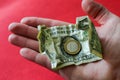 Hand with a one euro iron coin and one american dollar. Financial concept. Royalty Free Stock Photo