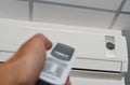 Hand open air conditioner on ceiling by remote control Royalty Free Stock Photo