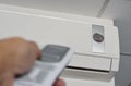 Hand open air conditioner on ceiling by remote control Royalty Free Stock Photo