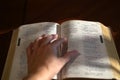 Hand on open bible that is on the table Royalty Free Stock Photo