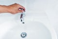 Hand open faucet of basin with flow water Royalty Free Stock Photo