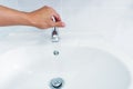 Hand open faucet of basin with flow water Royalty Free Stock Photo