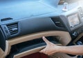 Hand man open glove compartment in car