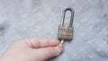 Hand open rusty metal padlock with small key Royalty Free Stock Photo