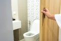 Hand open toilet door bathroom Royalty Free Stock Photo