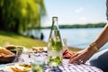 hand opening a bottle of sparkling water on a sunny day picnic Royalty Free Stock Photo