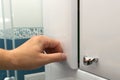 Hand opening a cabinet door