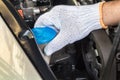 Hand opening car windscreen washer tank checking water level