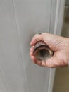 Hand opening the door with a key in the bathroom, close up Royalty Free Stock Photo