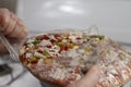 Hand Opening Frozen Pizza