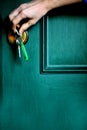 Hand opening the green house door with a key Royalty Free Stock Photo