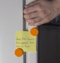 Hand opening refrigerator door and yellow sticker empty Royalty Free Stock Photo