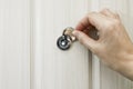 The hand opens the door peephole cover in the front door Royalty Free Stock Photo