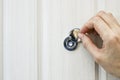 The hand opens the door peephole cover in the front door Royalty Free Stock Photo