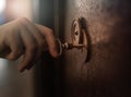 hand opens a heavy metal door with an antique key, archive, safe, top secret concept Royalty Free Stock Photo