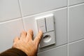 hand operating a light switch and power outlet Royalty Free Stock Photo