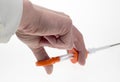 A hand operating a medical device syringe
