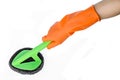 Hand with orange glove cleaning with brush. Royalty Free Stock Photo