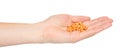 Hand with orange pills, medical care and help, chemical vitamins Royalty Free Stock Photo