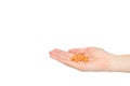 Hand with orange pills, medical care and help, chemical vitamins Royalty Free Stock Photo