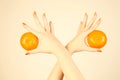 Hand with orange tangerine.