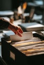 Hand organizing files in office environment for efficient document management Royalty Free Stock Photo