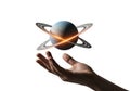 A hand is outstretched beneath a digitally created planet resembling Saturn, complete with rings. Royalty Free Stock Photo