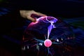 Hand over plasma lamp Tesla coil Royalty Free Stock Photo