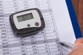 Hand Over Sheet With Digital Pedometer Royalty Free Stock Photo