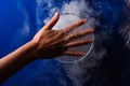 Hand over smoking blue glass Royalty Free Stock Photo