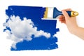 Hand with paintbrush painting sky Royalty Free Stock Photo