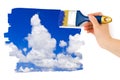 Hand with paintbrush painting sky Royalty Free Stock Photo